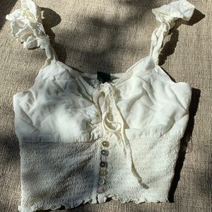 Super cute crop top w/ buttons and ruffle sleeves.